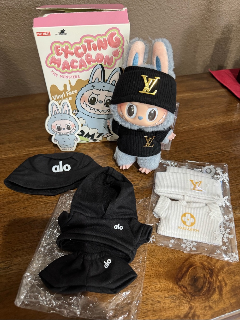 Pop Mart Labubu with 2 LV outfits and 1 Alo outfit and bucket hat.